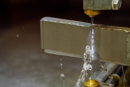 wire cutting machine working with metal workpiece with sparks at factory